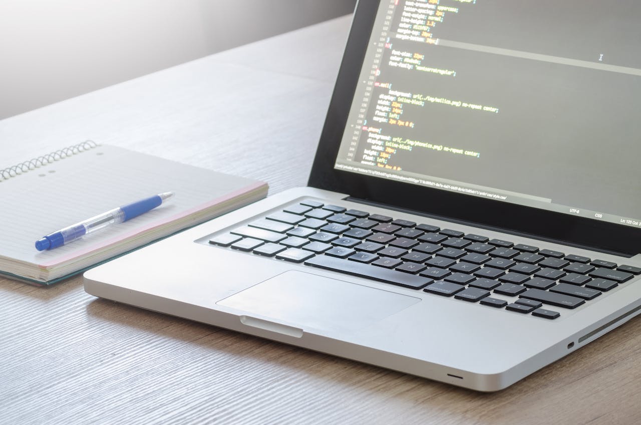 Modern workspace with a coding laptop, symbolizing digital solutions for businesses